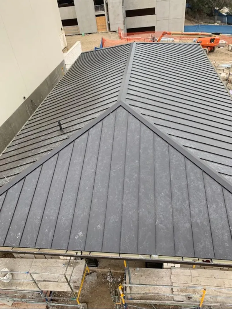 Commercial metal roof construction with crane equipment in Glendale